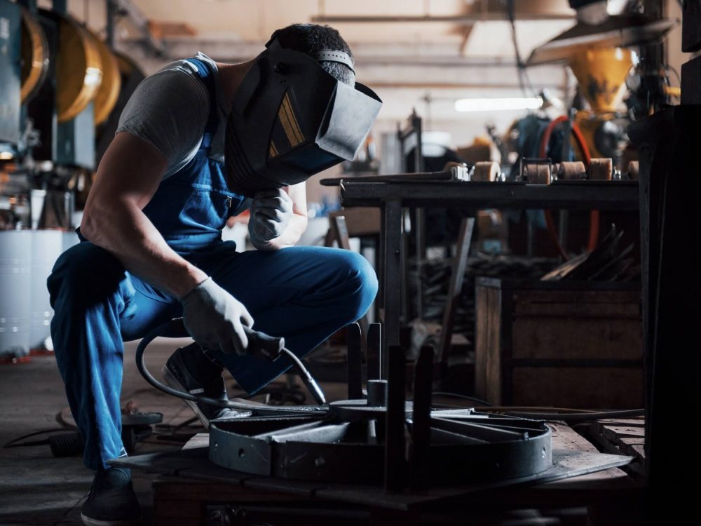 portrait-of-a-young-worker-at-a-large-metalworking-plant-the-welder-engineer-works-in-a-protective