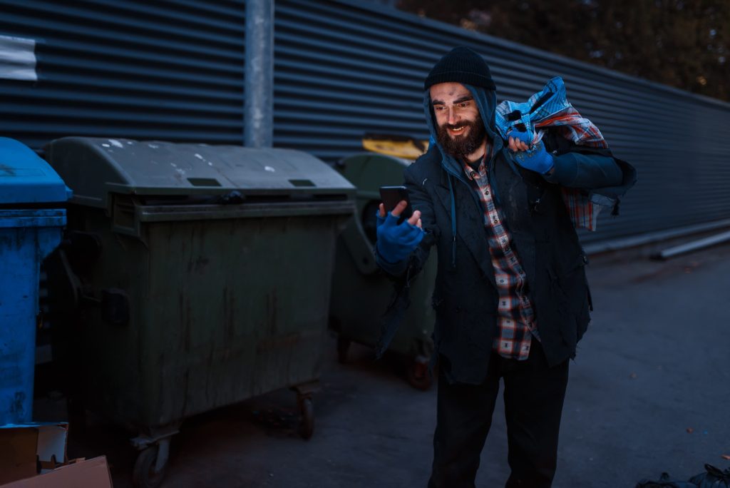 Happy beggar found mobile phone in trashcan