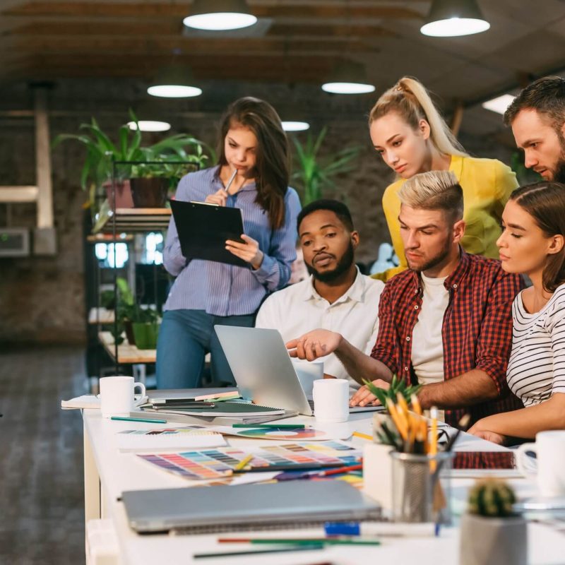 agency-coworkers-discussing-new-project-on-laptop