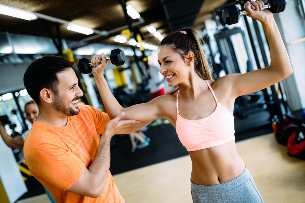 Personal trainer instructing trainee