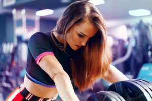 Portrait of a fit woman gym trainer